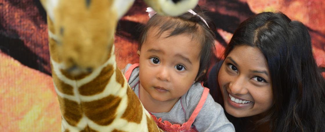 Mom and daughter with plush giraffe 